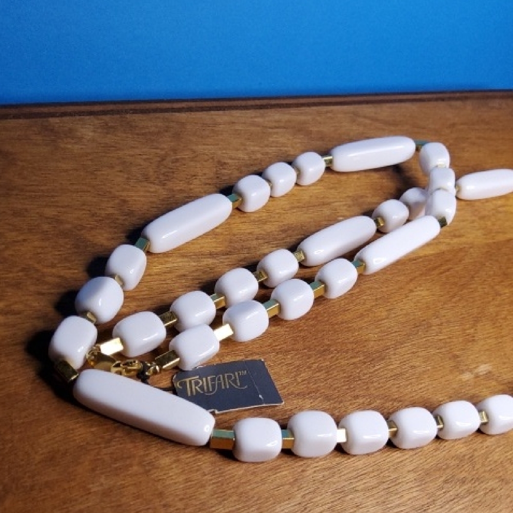 New Old Stock Trifari white geometrical lucite and goldtone spacers.